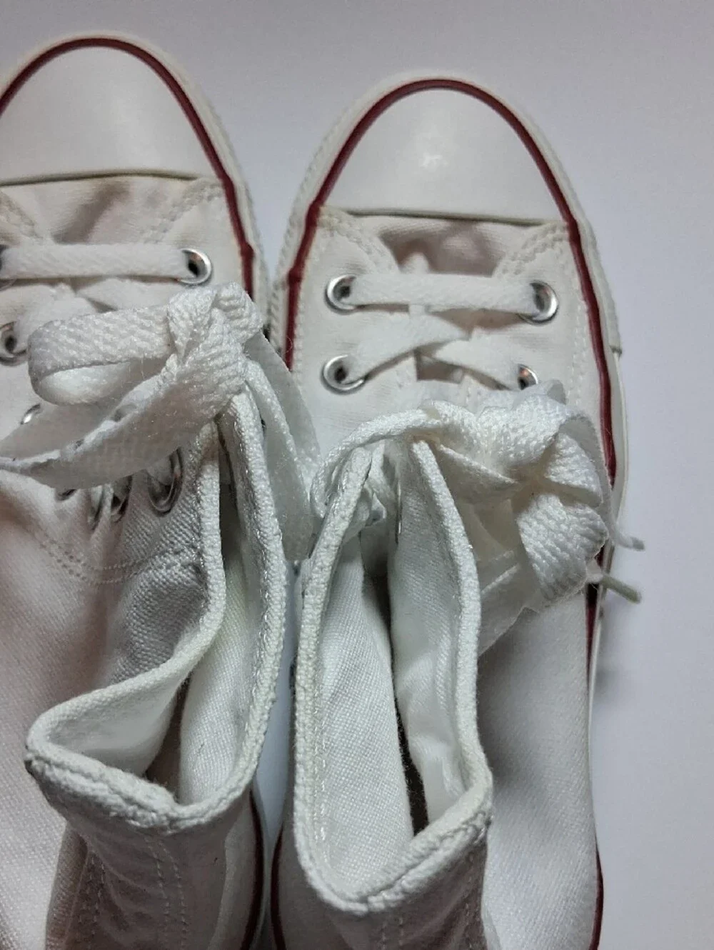 Converse white high-top sneakers with red trim